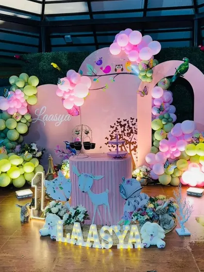 A full view of the pink enchanted forest setup, including light-up marquee letters for the name and age.