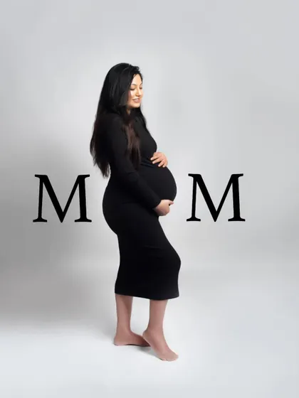 A simple and powerful solo portrait celebrating the mom-to-be. The clean background and classic black dress put all the focus on her and her beautiful baby bump.