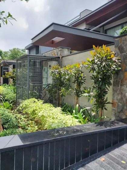 A view of a completed residential project, where our landscaping complements the modern architecture and natural stone walls.