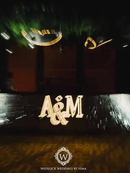 A custom-lit monogram for the couple, used as a focal point on the bar front. This personalized detail adds a modern and stylish touch to any celebration.