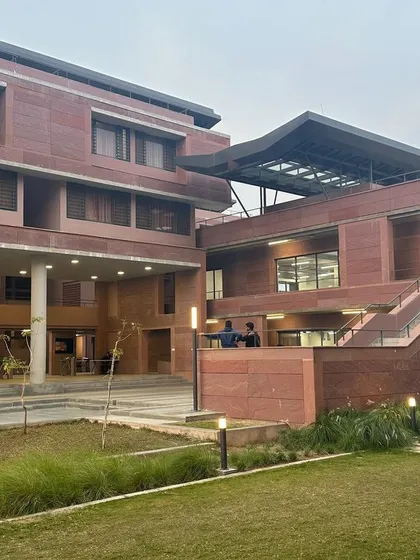 A view of the main courtyard and academic blocks at Azim Premji University, showing the integration of landscape and built form.