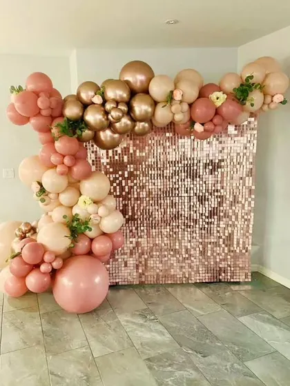 A beautiful rose gold sequin shimmer wall with a matching balloon garland. This kind of backdrop is versatile and perfect for adding a touch of glamour to birthdays, anniversaries, or bridal showers.