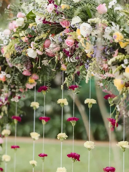 A close-up of the Haldi floral arch. I love mixing different flowers and colors to create a rich texture, and the hanging carnation strings added such a delicate and pretty touch.