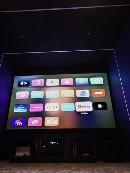 A duplicate of 50, this image shows the clean, minimalist front of the room, with the screen and AV equipment neatly arranged.