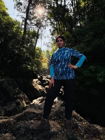 A trekker posing confidently on the rocky trail of Narasimha Parvatha.