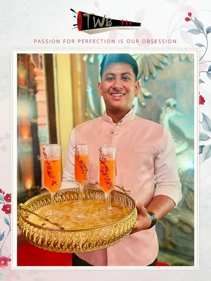 A tray of vibrant orange mocktails, beautifully presented in champagne flutes and ready to be served to guests.
