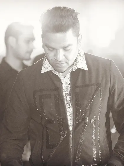 A sepia-toned shot that gives a timeless feel to the moment behind the decks. It's all about the craft of DJing.