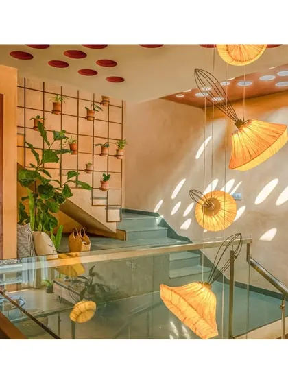 A closer view of the staircase, showing the play of light from the perforated ceiling. This detail transforms a functional element into a key design feature.