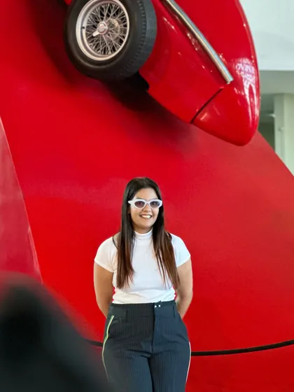 The white sunglasses add a pop of brightness to the look.