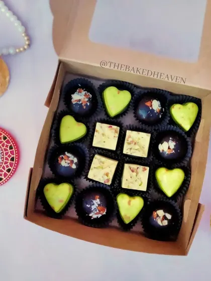A closer look at my Indian fusion chocolate box. It features heart-shaped Paan Delight chocolates, square Rasmalai Pistachio pieces, and dark chocolate Almond Crackle bites.