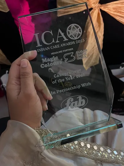 A close-up of my 'Cakepreneur of the Year 2025' award from the Indian Cake Awards. This beautiful plaque is a reminder of a decade of hard work and passion.