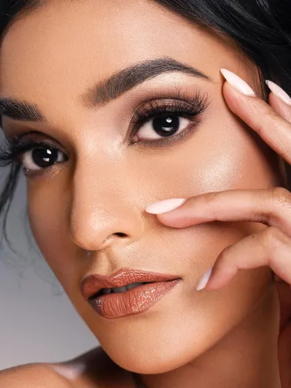 A close-up beauty shot for Nari lashes. The makeup is soft and neutral, allowing the lashes to stand out without overwhelming the look. The focus is on creating a naturally enhanced, beautiful eye.