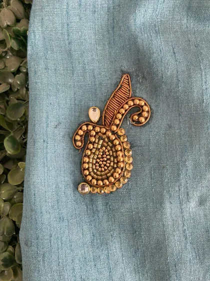 A single paisley butta created with Zardozi beadwork. This is a foundational motif in Indian ethnic wear design, and we focus on perfecting its shape and finish.