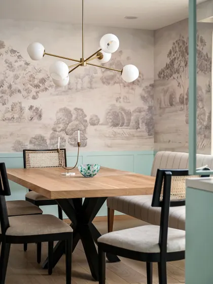 A custom mural is a powerful way to tell a story. In the Aqua Home's dining space, we commissioned a mural inspired by Bangalore's Gulmohar trees, paired with duck egg blue wainscoting to create a truly unique and personal dining experience.