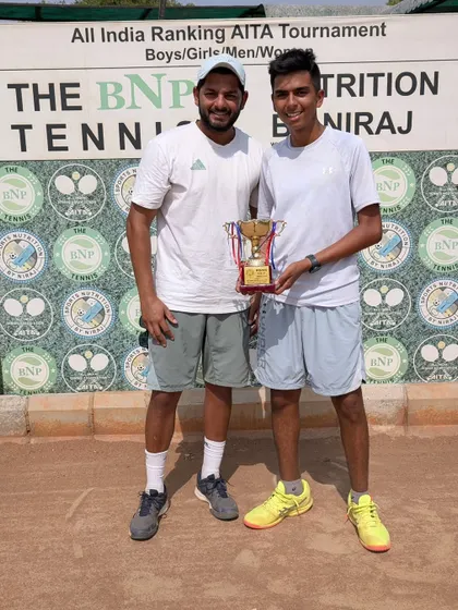 Arsh Kathuria with his coach and the U18 Boys Singles winner's trophy from the AITA Championship Series in Delhi.