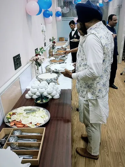 Guests enjoying a lavish spread served by my team. My staff is trained to manage the buffet efficiently, ensuring a smooth flow even at large gatherings.