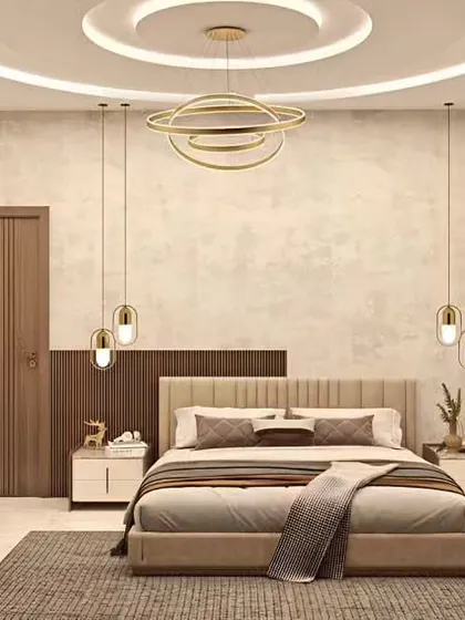 An elegant bedroom featuring a neutral color palette and sophisticated lighting. The design includes a stunning chandelier, pendant lights over the nightstands, and a beautiful coffered ceiling.