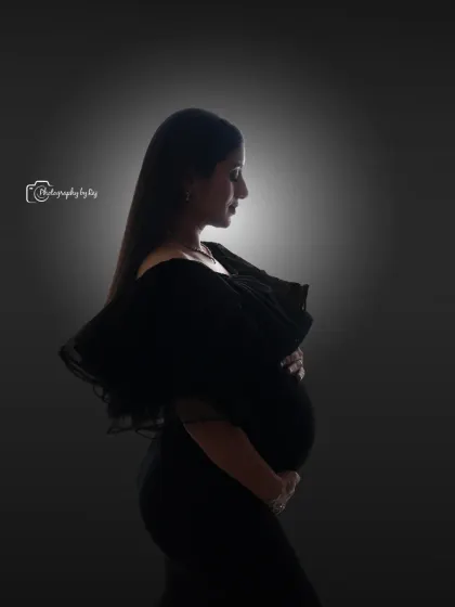 We use creative lighting to craft artistic and powerful images. This classic silhouette portrait, taken in our studio, beautifully highlights the stunning profile of the mother-to-be in a simple yet elegant black gown.