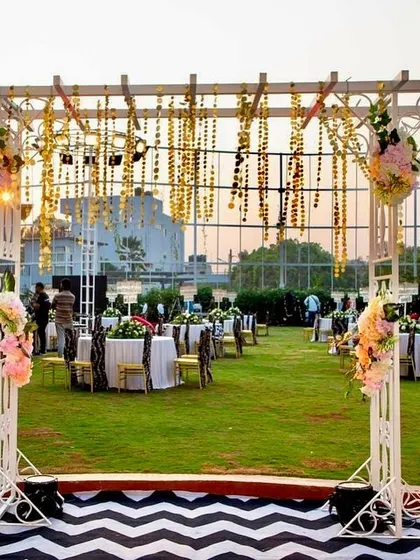 For the 60th birthday, we extended the black and white chevron theme to the outdoor seating and entrance arch. Themed furniture and chandelier centerpieces created a cohesive and elegant experience.