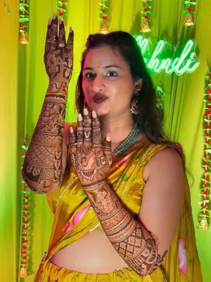 A playful bride showing off her intricate henna. My goal is to create a design that you love and feel excited to wear.