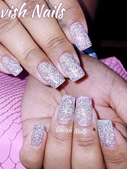 Full coverage silver holographic glitter on medium-length square nails for a high-impact, dazzling look.