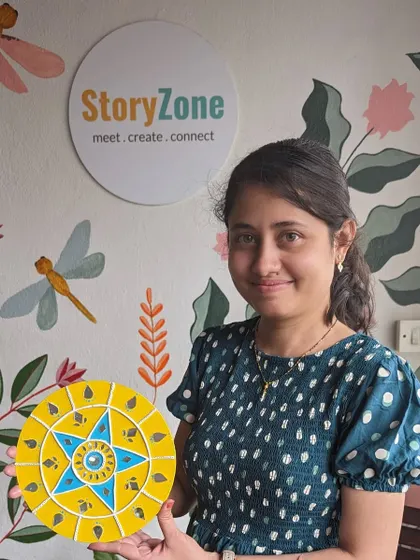 A participant with her finished Lippan art piece, a beautiful example of this traditional Indian craft.