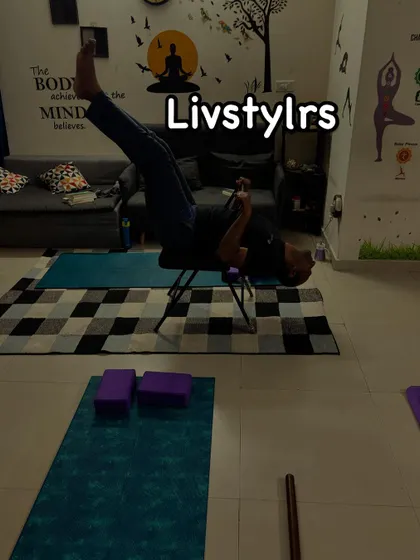 A client performs a core-strengthening exercise using a yoga chair for support. This demonstrates how we use props to create innovative and effective workouts.