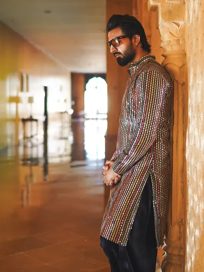 Lost in thought in a majestic palace corridor. These moments of quiet reflection are just as important as the loud celebrations.
