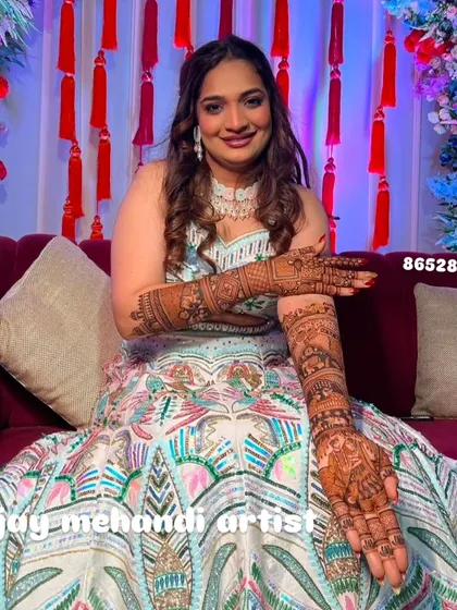 Another shot of the radiant bride, her hands posed to display the intricate details of her bridal henna.