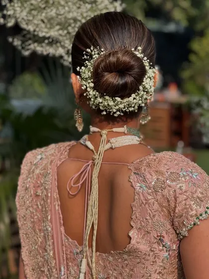A full circle of baby's breath around a classic bun creates a halo effect.