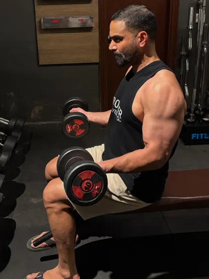 Focused during a dumbbell curl set. Every exercise, even assistance work, is done with intent to contribute to overall strength for BJJ and MMA.