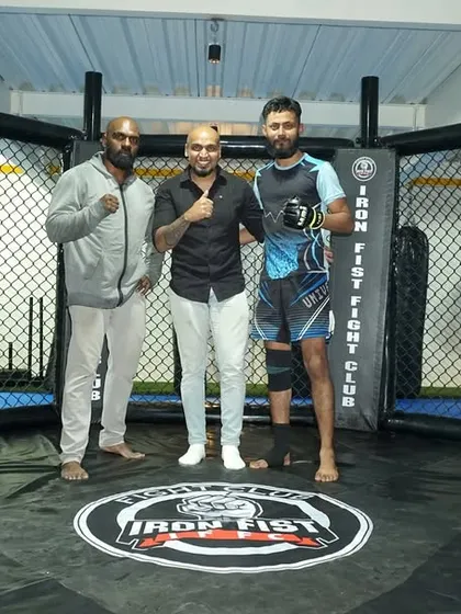 Posing inside the cage with our announcer and one of our fighters. We are proud of the professional network and community we have built.