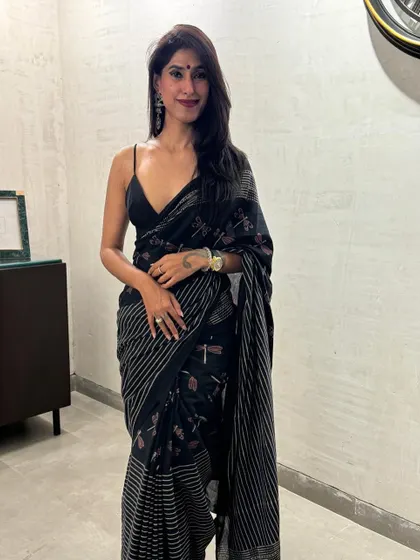 This black printed saree is a perfect example of timeless elegance. I paired it with a simple spaghetti strap blouse to give it a modern, chic feel. It's a versatile piece that can be dressed up or down for any occasion.