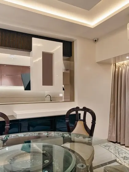 A view from the dining area into the kitchen at our Malad project. The open-concept design creates a cohesive living space, perfect for family interaction and entertaining.