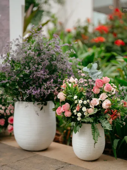 Pots of fresh pink and purple flowers add color to the entrance of the party.