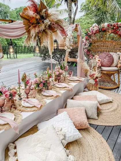 I design celebrations for every milestone. This chic boho baby shower combines low picnic-style seating, pampas grass, and a soft pink palette to create a stylish and comfortable atmosphere for the mom-to-be.