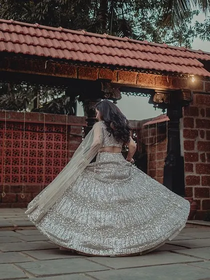 Another angle of the bride's twirl, showcasing the beautiful movement of her reception lehenga.
