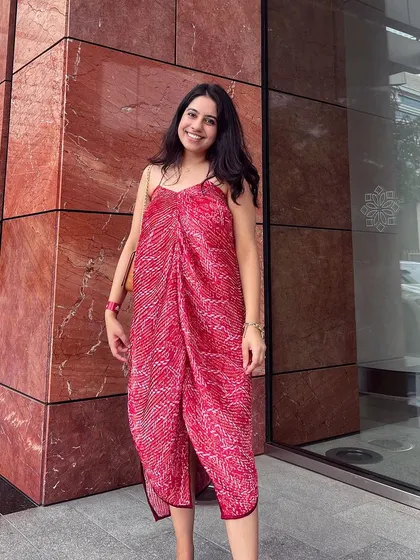 Another look at the pleated pink asymmetric dress, showing how it drapes beautifully on the body. This custom piece is a great example of how I tailor designs to suit individual styles.