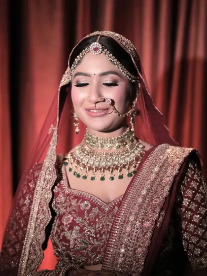 A moment of quiet reflection for the bride. Her makeup, with soft, shimmery eyes and a flawless base, looks beautiful and serene.
