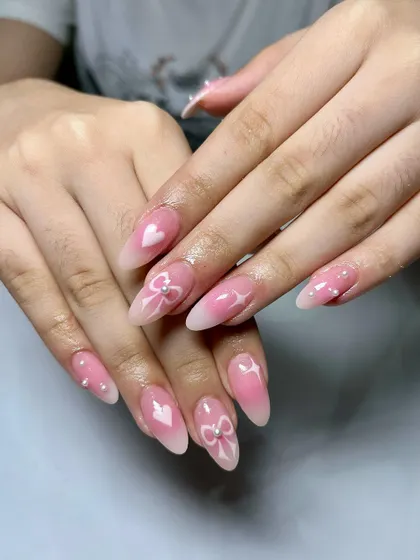 Elegance in every detail. This set features a soft pink base with delicate white hearts, bows, and pearl accents for a super sweet and romantic look.