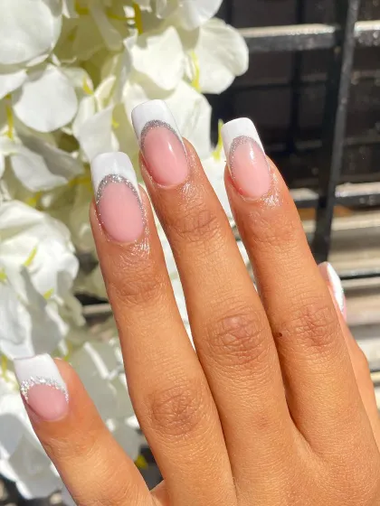 A classic French with a twist. This set features long, square-shaped extensions with a crisp white tip and a delicate silver glitter line for a touch of sparkle.
