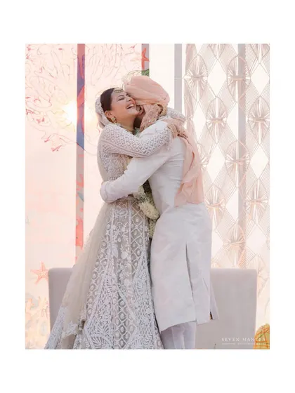 A joyful, candid embrace. This photo perfectly captures the happiness and relief after the wedding ceremony is complete.