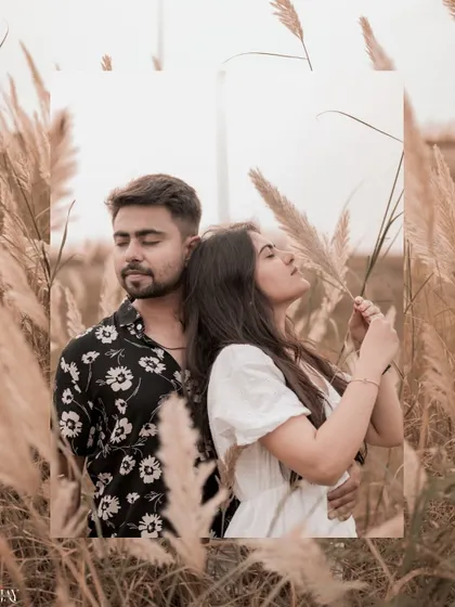A stylish shot of the couple standing back-to-back, framed by the tall grass.