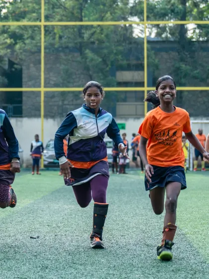 Running into the week with smiles and energy. This photo captures the pure joy and enthusiasm of our campers, a common sight at the Jude Felix Hockey Academy.