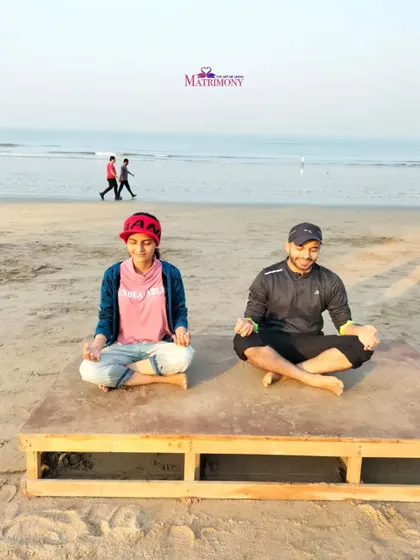 A couple meditating on a platform by the beach. This serene image reinforces the idea that a shared spiritual journey can be peaceful and beautiful.