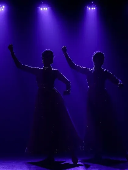 A silhouette of our duet, created by dramatic purple backlighting. This technique creates a powerful and mysterious mood on stage.