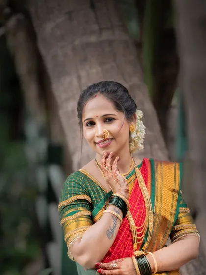 A serene portrait taken during a Vat Purnima shoot. The woman's gentle smile and traditional attire, including the nath and gajra, perfectly capture the devotional spirit of the festival.