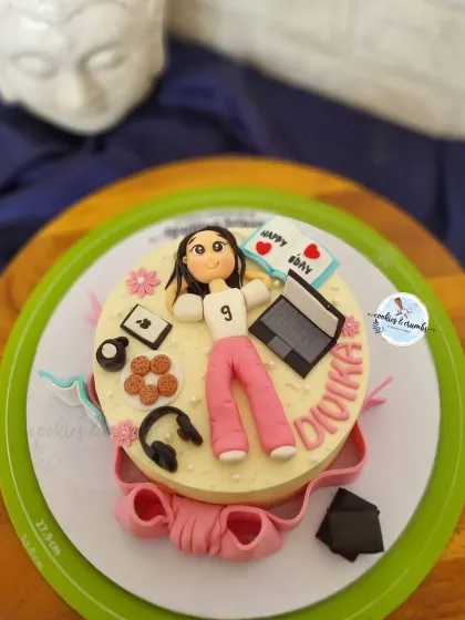 This cake is a perfect match for the birthday girl's hobbies. I created fondant versions of her laptop, headphones, cookies, and even a little book to capture her personality in edible form.