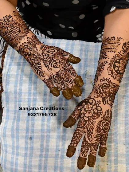 A beautiful floral design for a wedding guest, combining different patterns on each hand for a unique and stylish look.