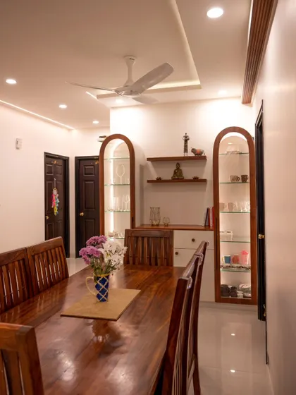 A wide view of the dining area, showing the illuminated crockery cabinets and other ambient lighting.